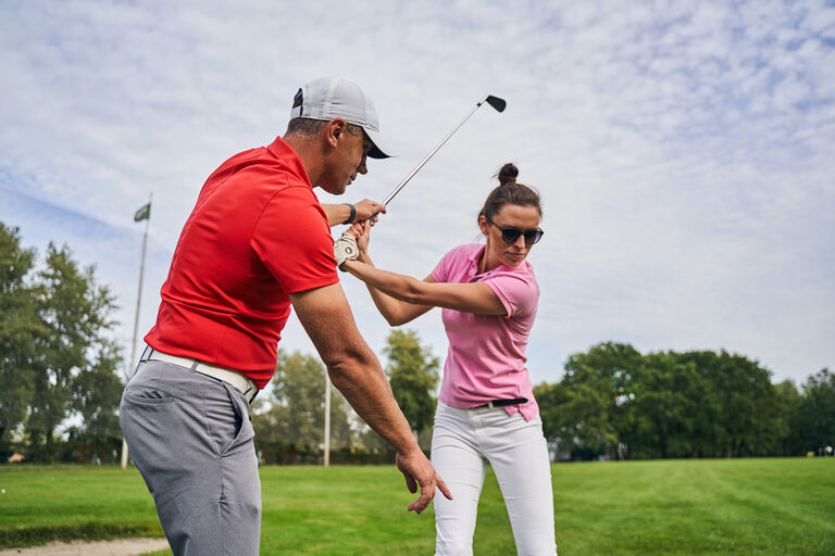 coach-assisting-backswing
