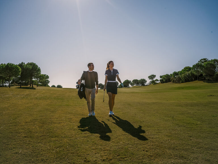 player-couple-walking-golf-course